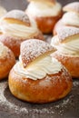 Traditional winter sweet Semla semlor or fastlagsbulle flavored with cardamom, filled with almond paste and whipped cream closeup