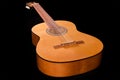 Traditional wooden acoustic guitar on a black background