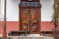 A traditional wooden Black Sea village house with two doors and wooden benches on either side of the entrance. Royalty Free Stock Photo