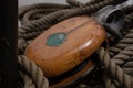 a traditional wooden block and rigging ropes on the deck of US coastguard tallship Eagle