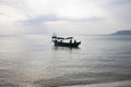 Traditional wooden boat in Cambodia. Sunrise sea landscape photo. Sea and sky view with boat silhouette. Royalty Free Stock Photo
