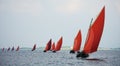 Traditional wooden boat with read sail. Royalty Free Stock Photo