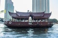 Traditional wooden boat with restaurant on the Chao Phraya river cruising tour. River view of the tourist boat takes visitors for