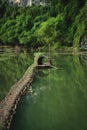 Traditional wooden boat in river along green grown lush karst mountains, Ninh Binh, Vietnam Royalty Free Stock Photo