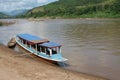 Public transport by very old wooden vessel at Mekong river, Laos