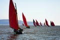 Traditional wooden boats with read sail. Royalty Free Stock Photo