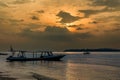 Traditional wooden boats on a tropical beach at sunset Royalty Free Stock Photo