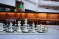 a traditional wooden chess board set up on the table in an old library waiting for players to play a quiet game Royalty Free Stock Photo