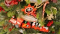 Traditional wooden Christmas toys on a coniferous tree close-up. Christmas tree with beautiful toys and candy cane. Vintage wooden