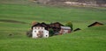 Traditional wooden cottage mountain houses in the green field in the dolomites. Housing in Italian apls. Alpine region