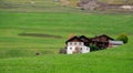 Traditional wooden cottage mountain houses in the green field in the dolomites. Housing in Italian apls. Alpine region