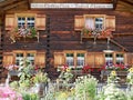 Traditional wooden country house with cottage garden. St. Antoenien, Grisons, Switzerland. Royalty Free Stock Photo