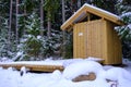 Traditional wooden country toilet in winter in Latvia