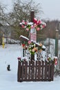 Traditional wooden cross on crossroad in old village of Belarus in winter day