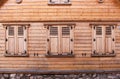 Traditional wooden facade of an old town buildings in Latvia. Wooden house facade with closed shutters. Royalty Free Stock Photo
