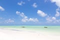 Traditional wooden fishing boats on picture perfect white sandy beach with turquoise blue sea, Paje, Zanzibar, Tanzania. Royalty Free Stock Photo