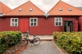 Traditional wooden house in historical area of Copenhagen, Denmark. Bicycle parked past old house on city street.