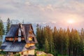 Traditional wooden house in the mountains on a green field Mount Royalty Free Stock Photo