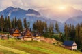 Traditional wooden house in the mountains on a green field Mount Royalty Free Stock Photo