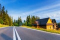 Traditional wooden house in the mountains on a green field Royalty Free Stock Photo