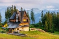 Traditional wooden house in the mountains on a green field Mountains, Poland Royalty Free Stock Photo