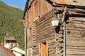 Traditional wooden houses with the bell tower of Saint Sebastien Church in the background, Ceillac