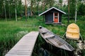 Traditional wooden hut. Finnish sauna on the lake and pier with fishing boats Royalty Free Stock Photo
