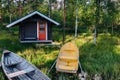 Traditional wooden hut. Finnish sauna on the lake and pier with fishing boats Royalty Free Stock Photo