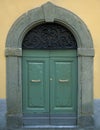 Traditional wooden Italian door with stone frame Royalty Free Stock Photo