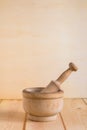Traditional wooden mortar en pestle close up on neutral wooden background Royalty Free Stock Photo