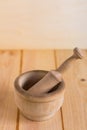 Traditional wooden mortar en pestle close up on neutral wooden background Royalty Free Stock Photo