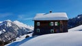 Traditional wooden mountain hut in beautiful winter landscape. Walsertal, Vorarlberg, Austria.