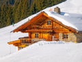 Traditional wooden mountain hut on sunny winter day. Alps, Europe Royalty Free Stock Photo
