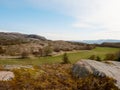 A traditional wooden red house cabin bellow rocky hill. House in classic Norway design Royalty Free Stock Photo