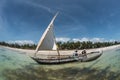 Traditional wooden sail boat on turquoise water in the Indian Ocean in Diani Beach, Watamu, Kenya, Zanzibar, Maldives island