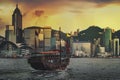 Traditional wooden sailboat sailing in victoria harbor at sunset in Hong Kong, China