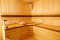 Traditional wooden sauna. Classic interior. Empty seats, bucket lies Royalty Free Stock Photo