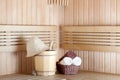 Traditional wooden sauna for relaxation with bucket of water Royalty Free Stock Photo