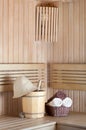 Traditional wooden sauna for relaxation with bucket of water Royalty Free Stock Photo