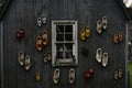 Traditional wooden shoes in all sizes and colors hanging at a wall of an old house Royalty Free Stock Photo