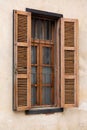 Traditional wooden shuttered window in Neve Tzedek, Tel Aviv-Yafo, with iron bars and textured stucco wall, showcasing classic Royalty Free Stock Photo