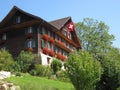 Traditional wooden Swiss House with flag