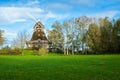 Traditional wooden windmill in a lush garden Royalty Free Stock Photo