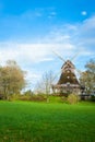 Traditional wooden windmill in a lush garden Royalty Free Stock Photo