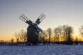 Traditional wooden windmill by sunset in winter season Royalty Free Stock Photo