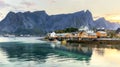 Traditional yellow rorbu house in drying flakes for stockfish cod fish in norwegian fjord in summer. Sakrisoy fishing village, Royalty Free Stock Photo