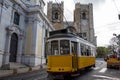 Traditional yellow tram in front of Lisbon Cathedral in Lisbon, Portugal Royalty Free Stock Photo