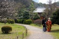 Traditional Young Japanese couple out for a stroll in the park in downtown Tokyo