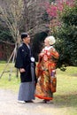 Traditional Young Japanese couple out for a stroll in the park in downtown Tokyo