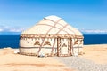 Traditional Yurt. National nomadic old house of Central Asia with blue sky on background. Issyk Kul high alpine lake in